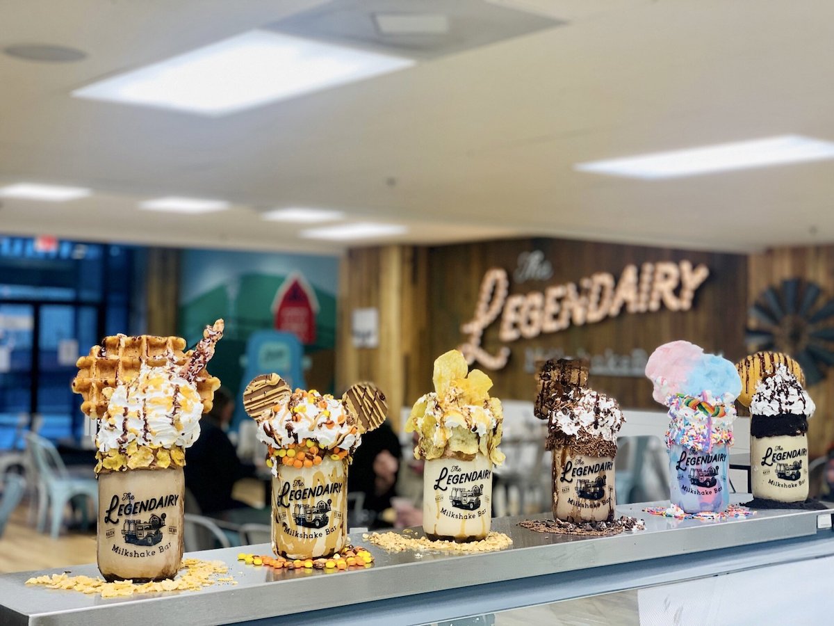 Elaborate milkshakes with assorted toppings on display at "the legendary" dessert shop.